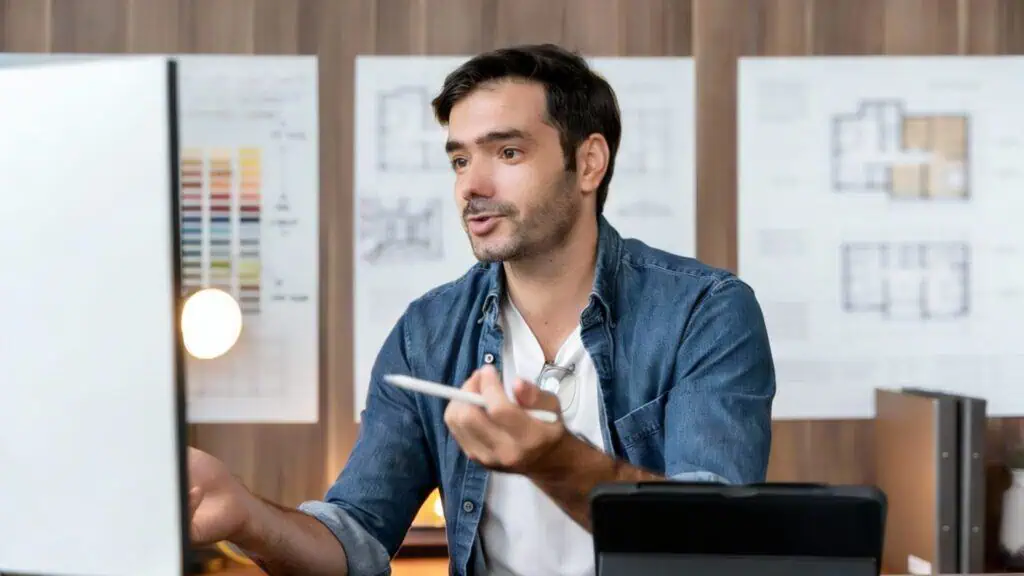 Person working at a desk with plans.