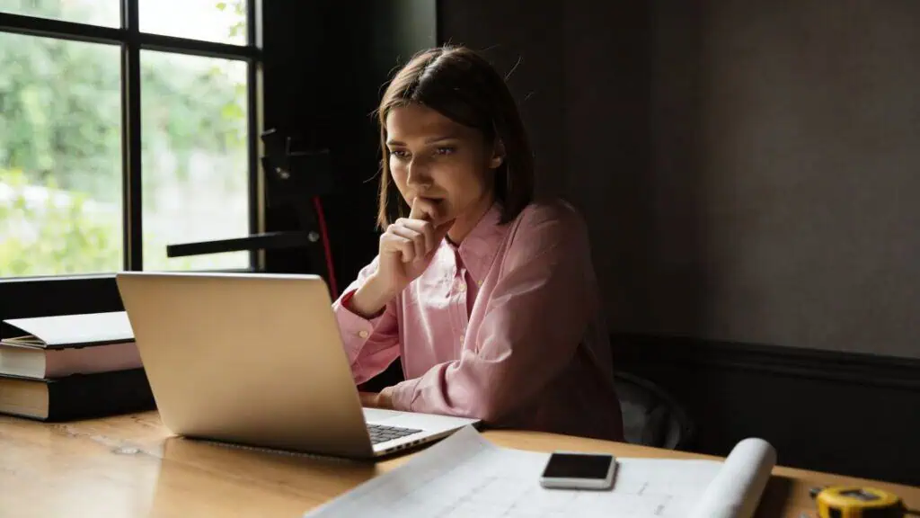 Person working at a desk with laptop.